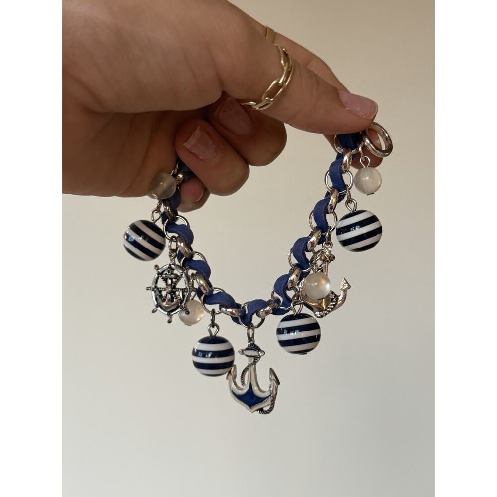 Vintage nautical charm bracelet featuring blue suede-wrapped chain with anchor